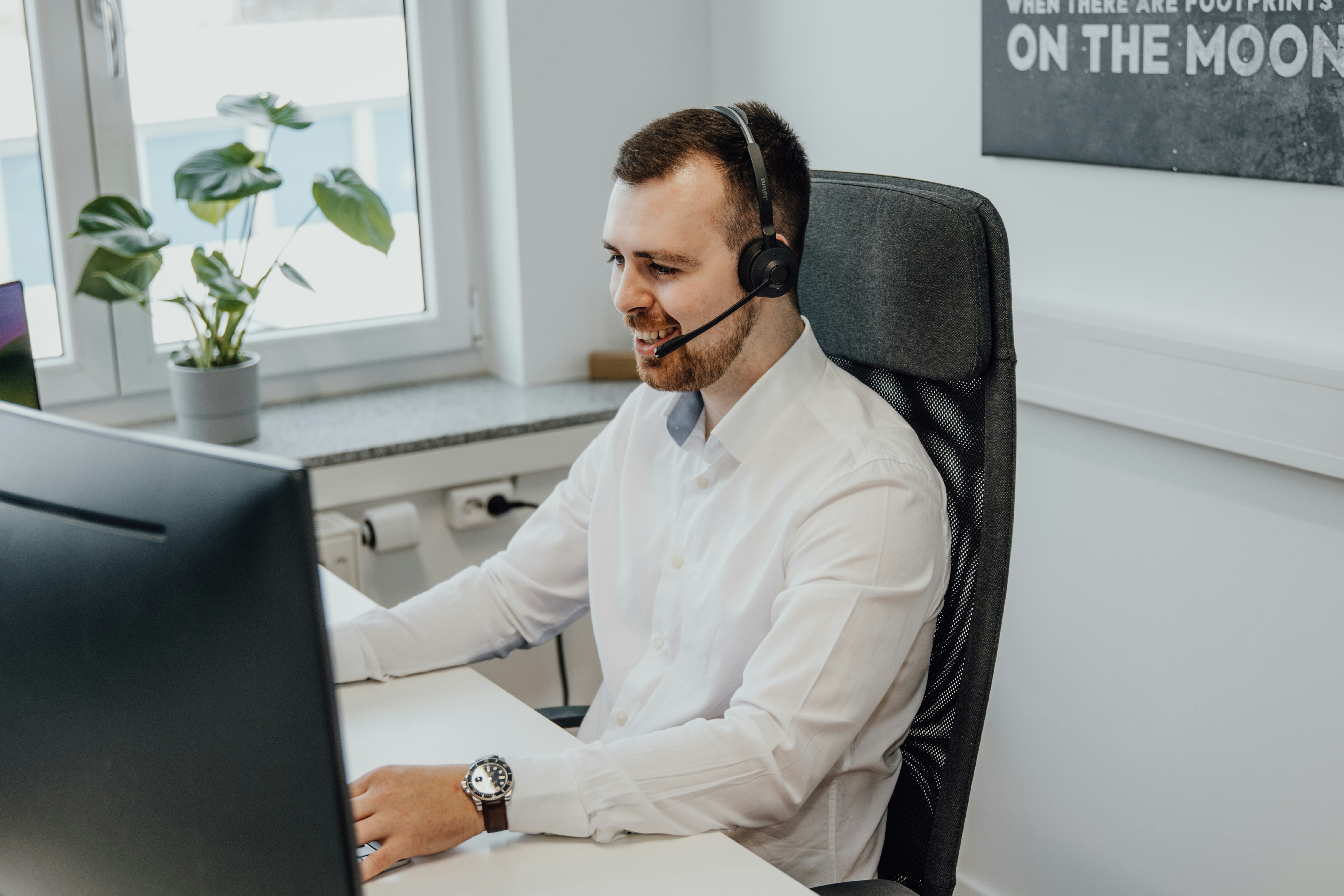 A man in white longsleeve polo doing cold calling.